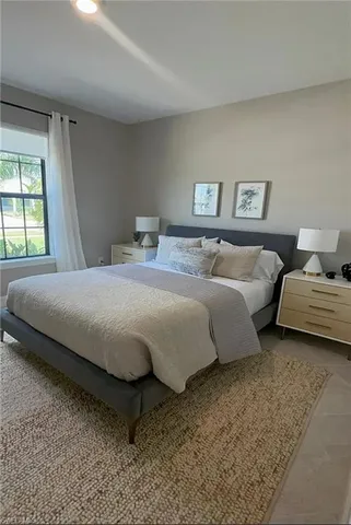 a bedroom with bed and a window