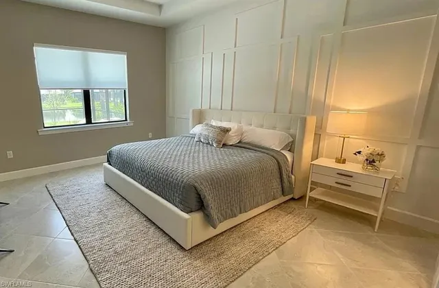 a bedroom with a bed and windows