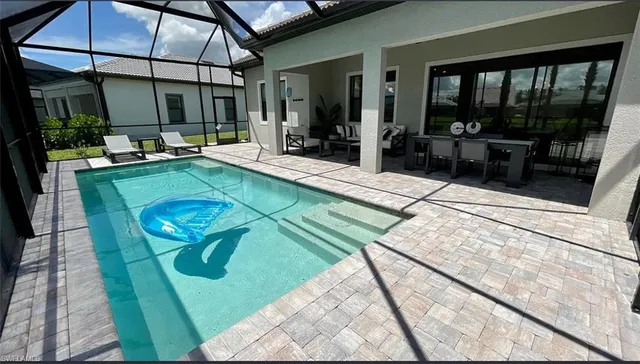 a view of swimming pool with a patio
