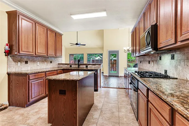 a kitchen with stainless steel appliances granite countertop a stove sink and cabinets