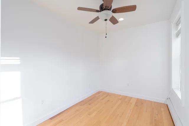 a view of a room with a fan and a window