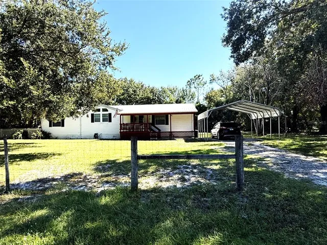 a view of a house with swimming pool and a yard