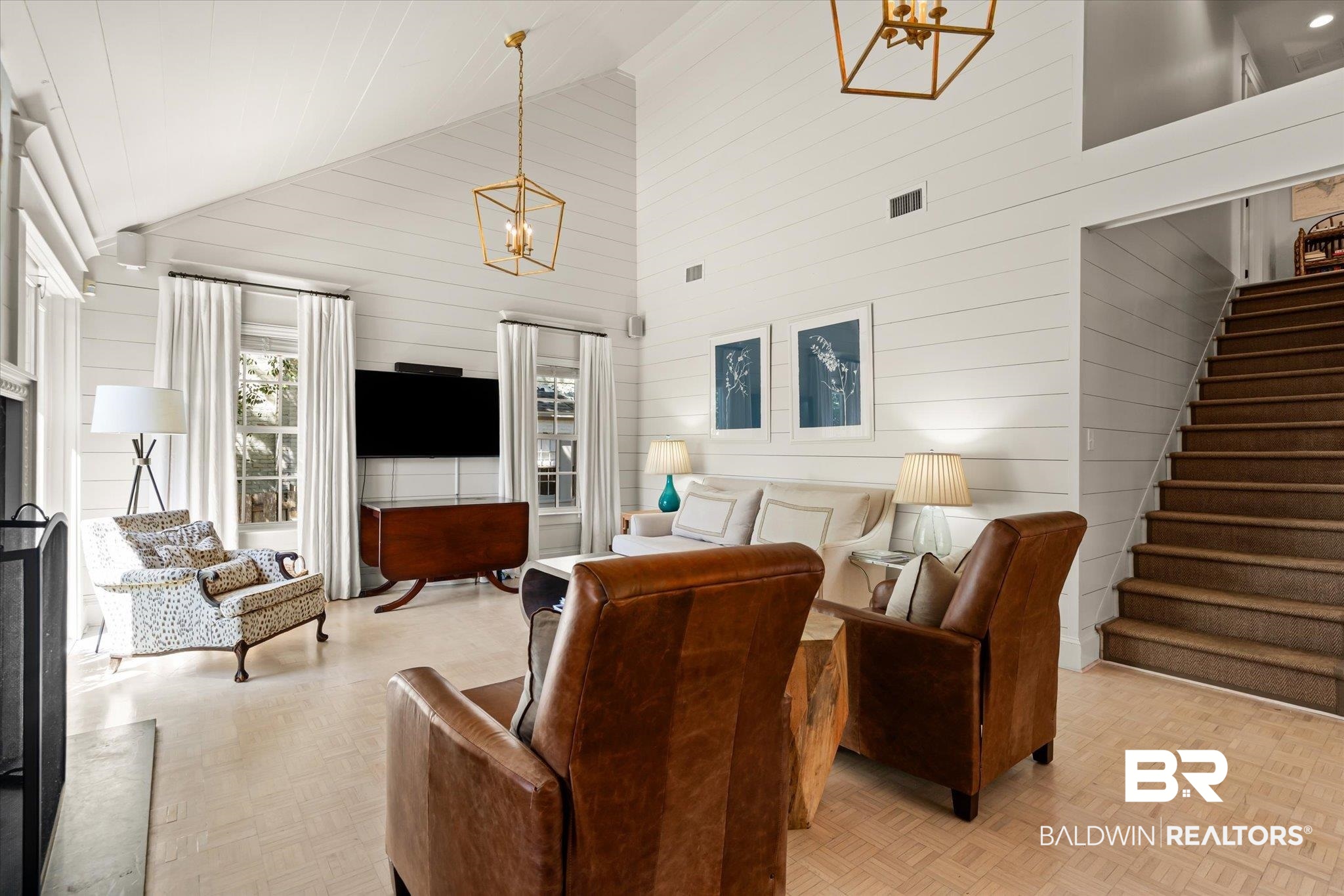 3921 McGregor Court Mobile, AL 36608 - Photo 21 of 41 Living area featuring stairway, a notable chandelier, visible vents, and high vaulted ceiling