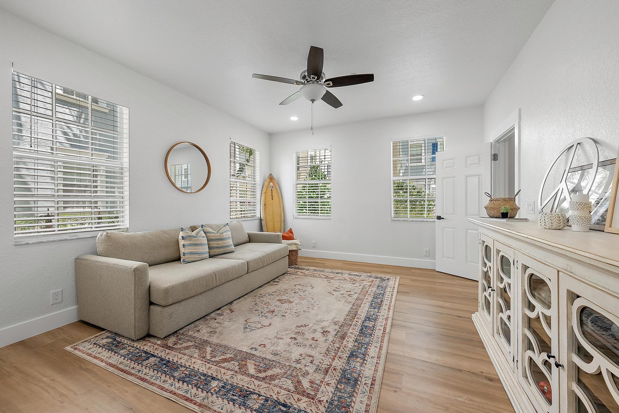 107 Pond Apple Lane, Unit 105 Jupiter, FL 33458 - Photo 6 of 37 a living room with furniture and a large window