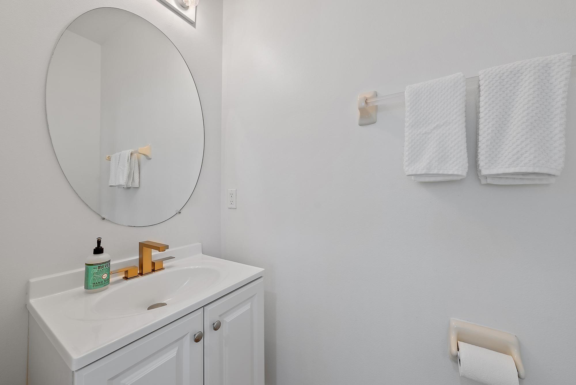 107 Pond Apple Lane, Unit 105 Jupiter, FL 33458 - Photo 7 of 37 a bathroom with a sink and a mirror