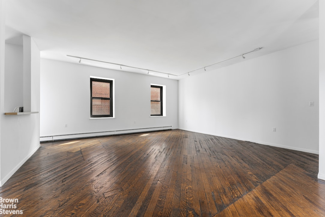 454 West 46th Street, Unit 4CS Manhattan, NY 10036 - Photo 8 of 18 a view of an empty room with wooden and a window