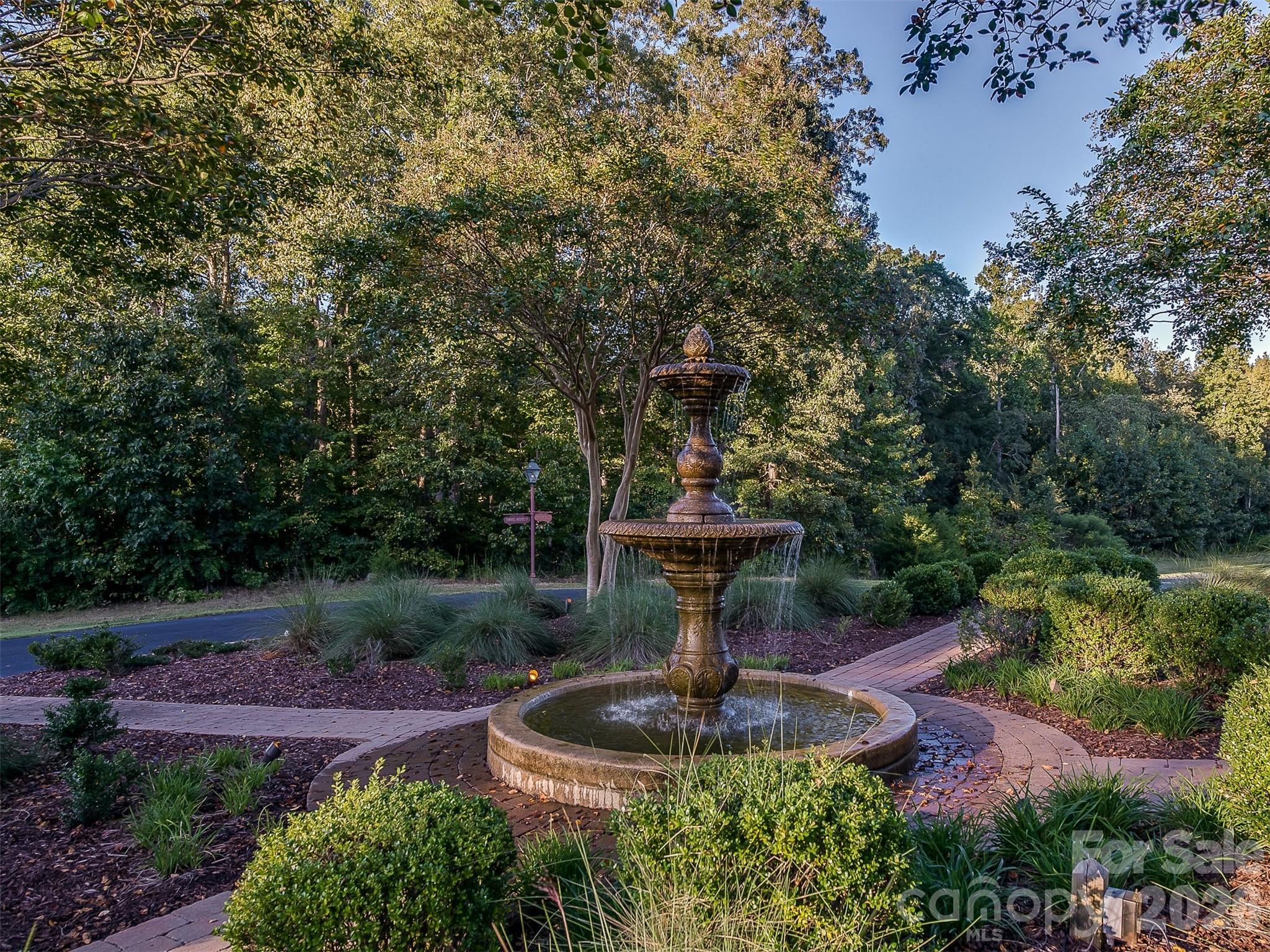 7316 Barrington Ridge Drive, Unit 14 Fort Mill, SC 29707 - Photo 6 of 10 a view of a fountain in a yard with potted plants