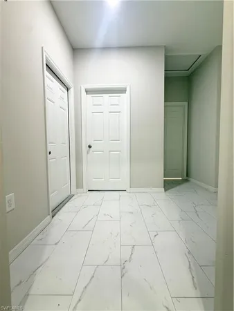 an empty room with windows and closet