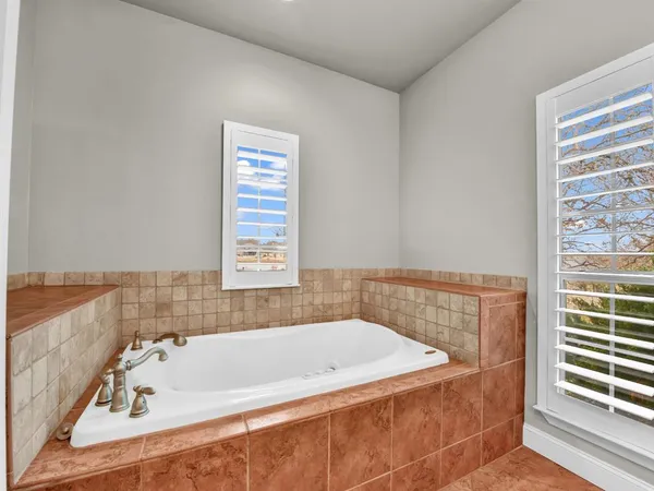 a bathroom with a bathtub and a window