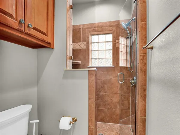 a bathroom with a shower and toilet