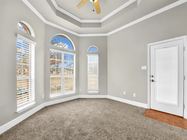 an empty room with windows and closet