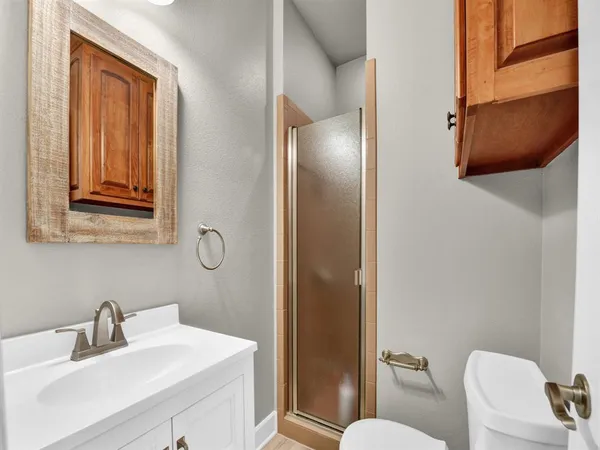a bathroom with a sink mirror and toilet