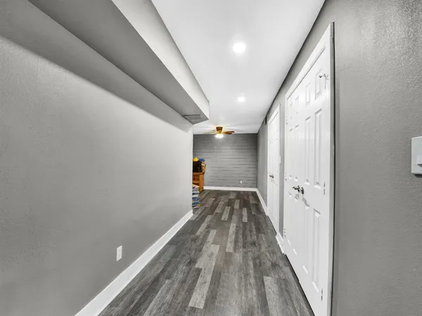 a view of a hallway with wooden floor