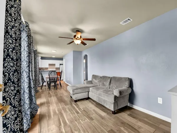 a living room with furniture and a chandelier