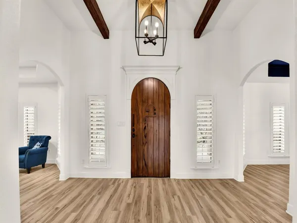 a view of a room with wooden floor windows and a wooden floor