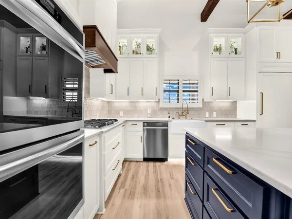 a kitchen with a sink stove and cabinets