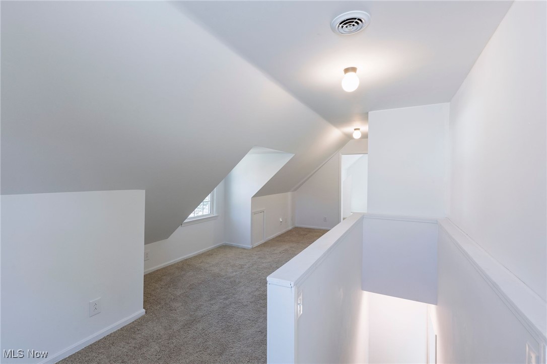 106 Berkley Road Elyria, OH 44035 - Photo 10 of 16 Bonus room with lofted ceiling and light colored carpet