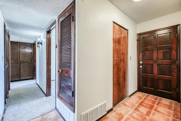 a view of hallway with stairs and wooden floor