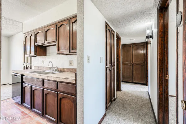 a bathroom with a granite countertop sink and a mirror