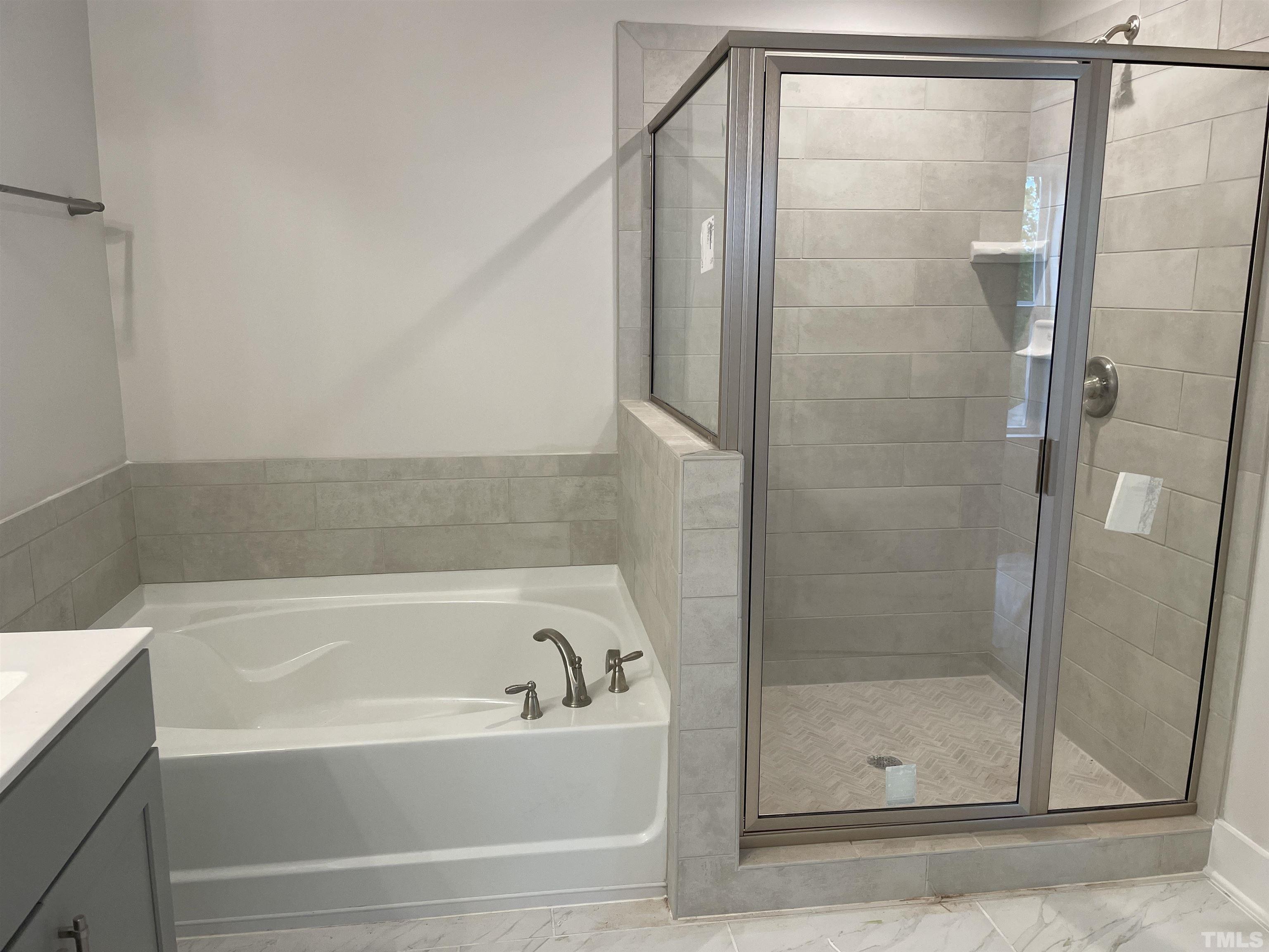 1308 B Castlebay Road Durham, NC 27704 - Photo 20 of 25 a bathroom with a bathtub and a shower