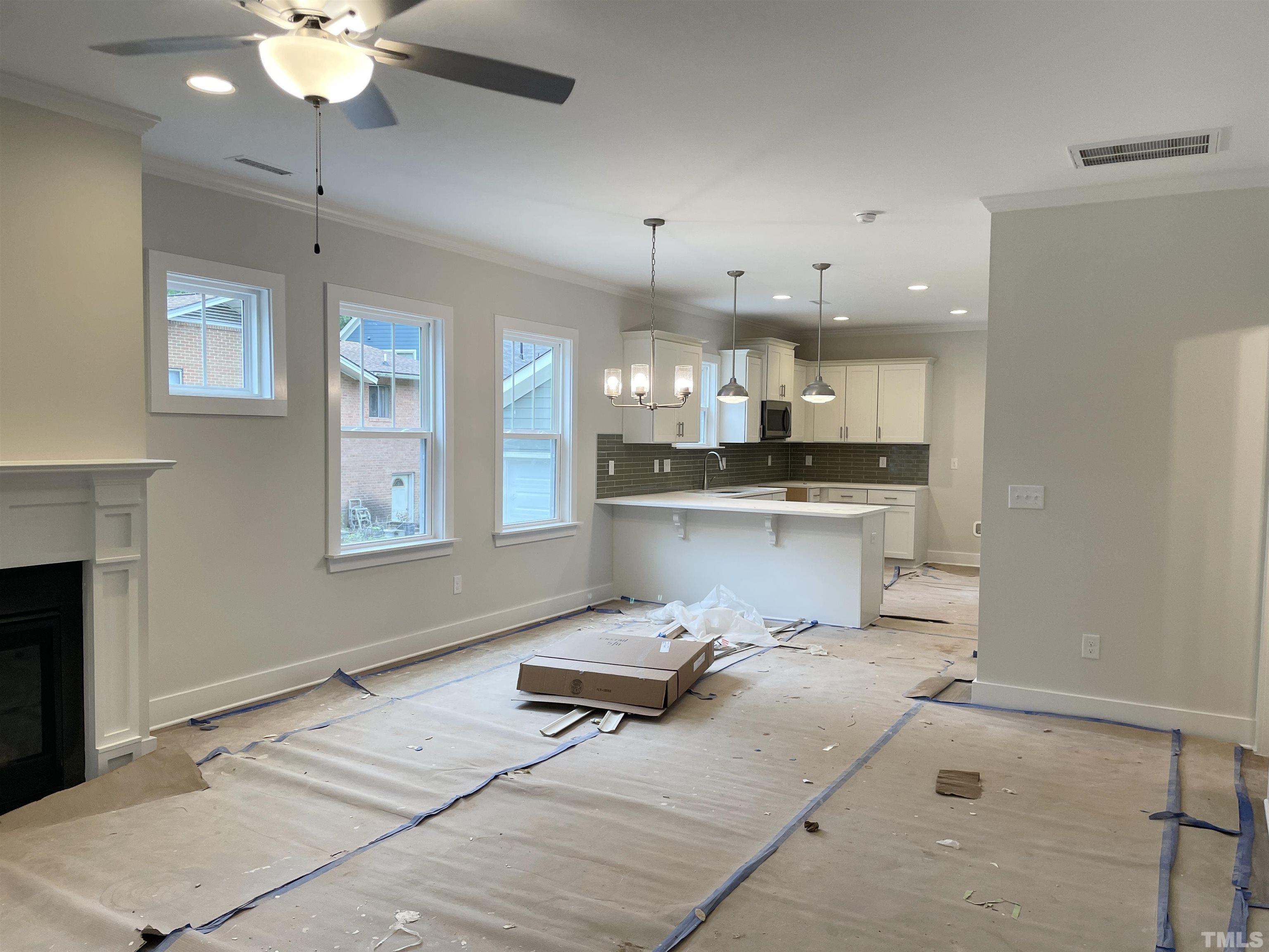 1308 B Castlebay Road Durham, NC 27704 - Photo 4 of 25 a room with stainless steel appliances kitchen island granite countertop furniture and a fireplace