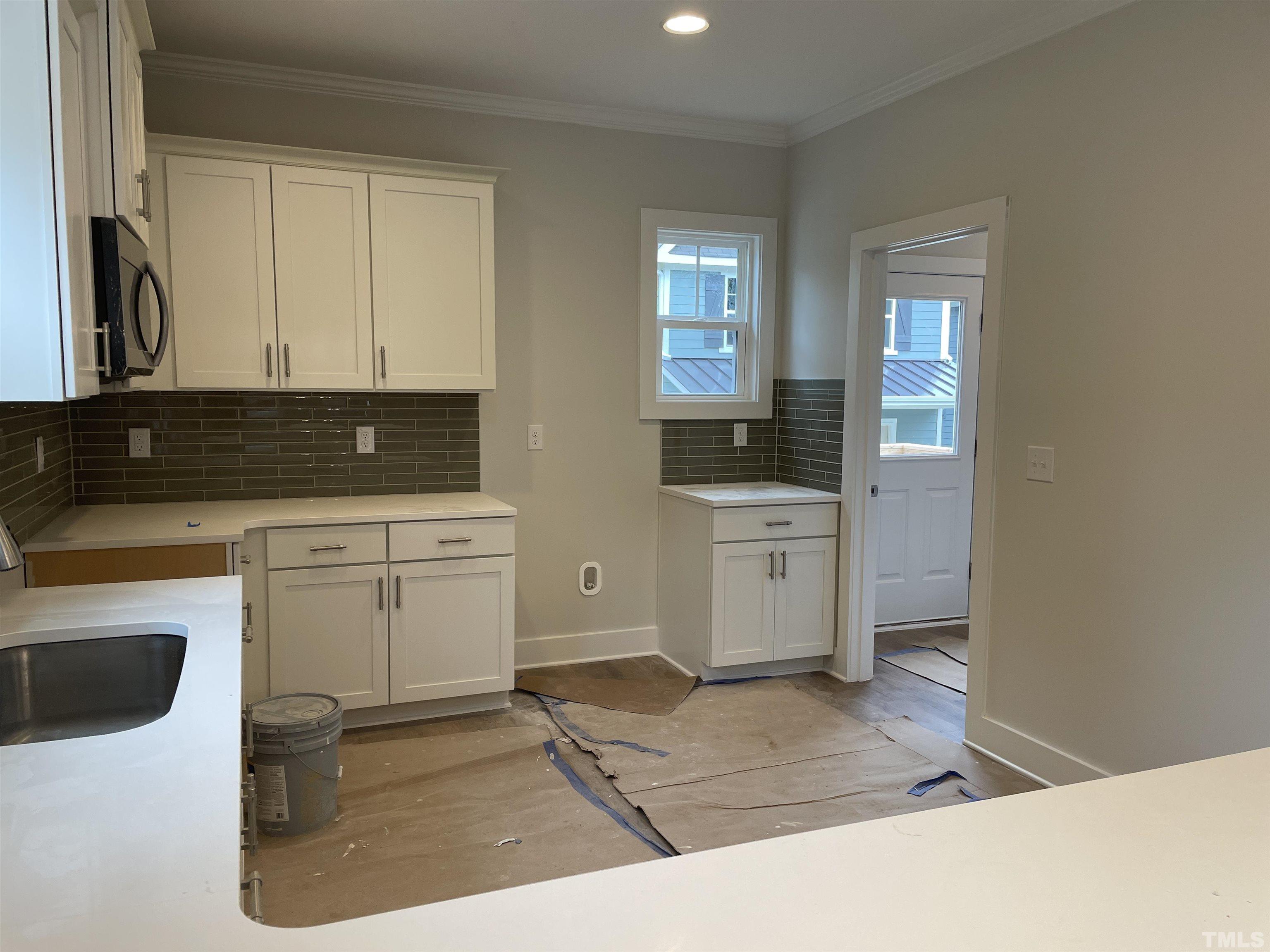 1308 B Castlebay Road Durham, NC 27704 - Photo 9 of 25 a kitchen with a sink stove and cabinets