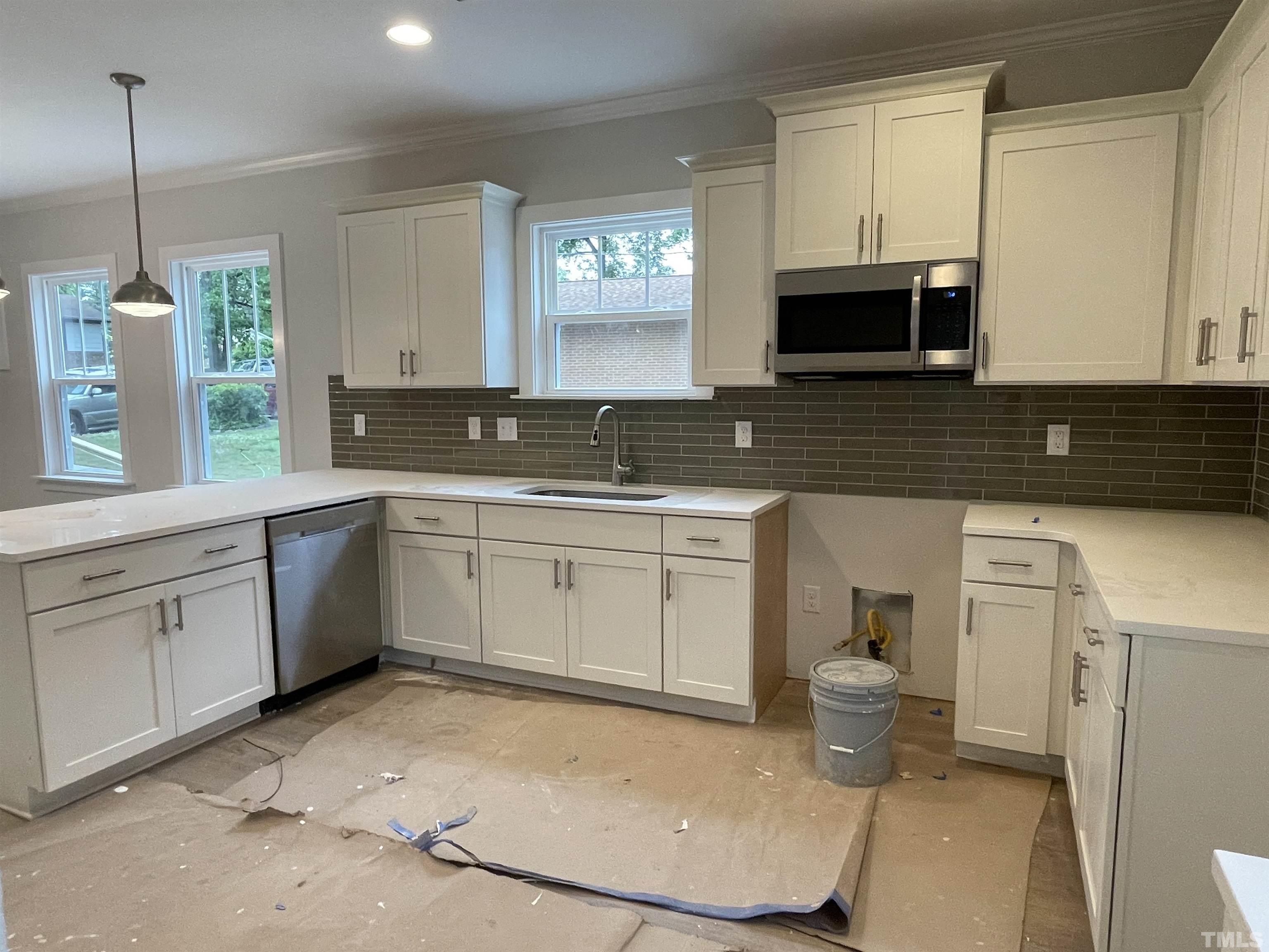 1308 B Castlebay Road Durham, NC 27704 - Photo 10 of 25 a kitchen with a sink stove and cabinets