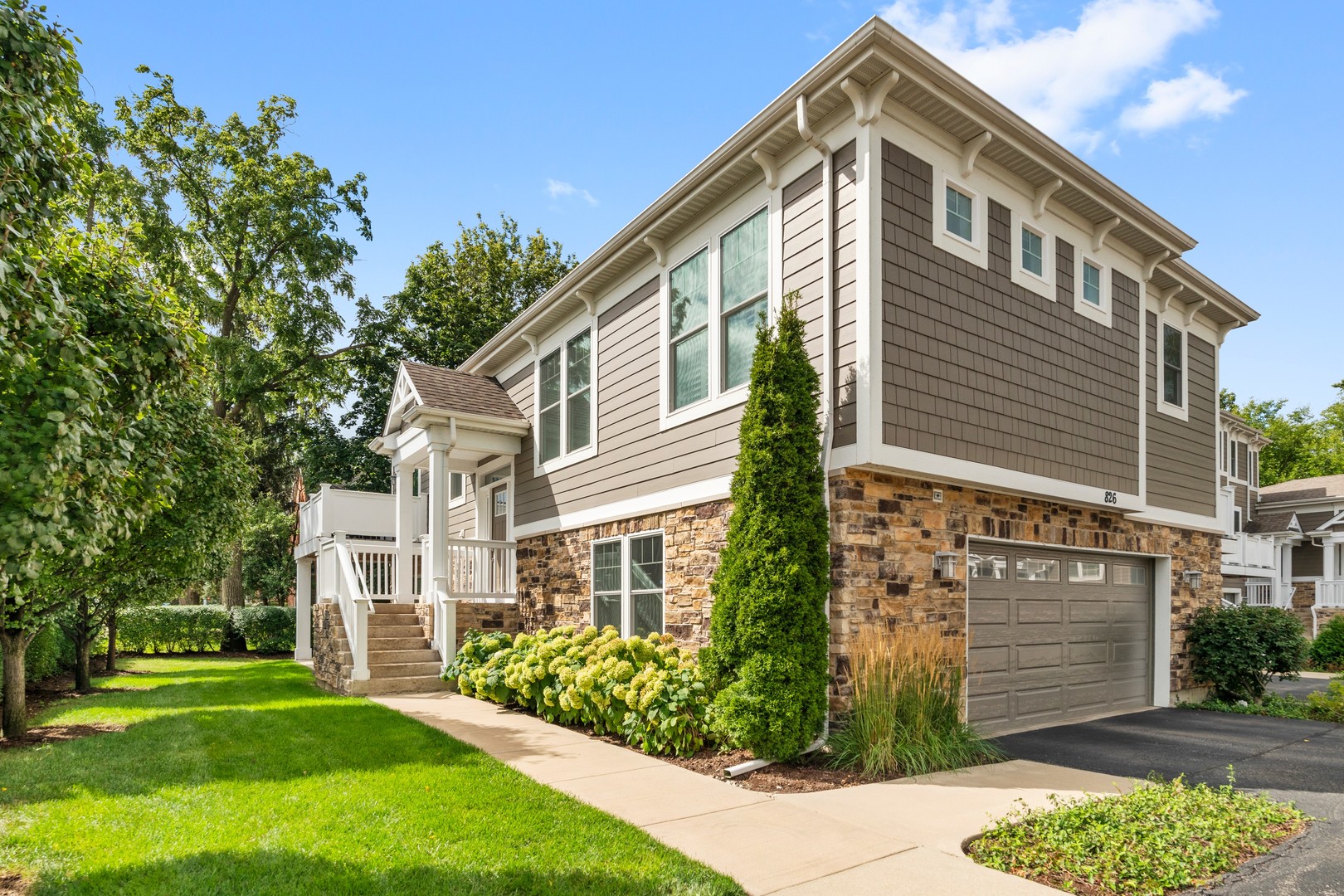826 Chestnut Street Deerfield, IL 60015 - Photo 1 of 28 a front view of a house with a garden