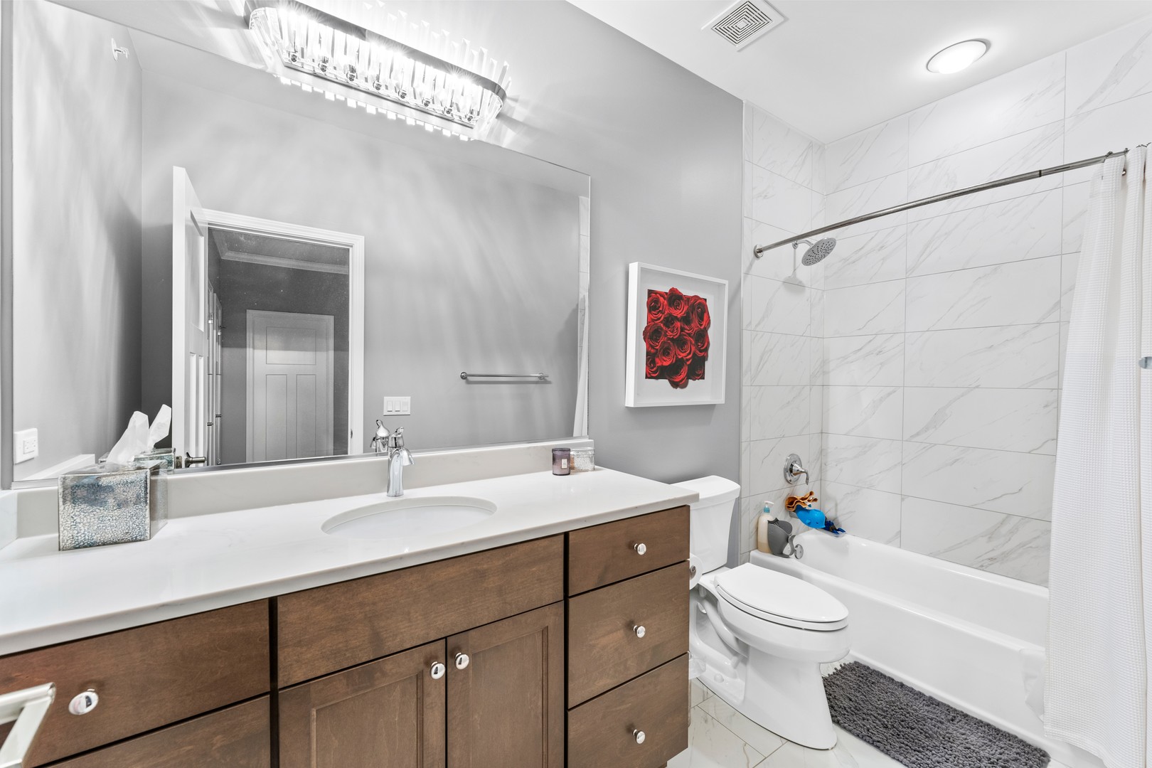 826 Chestnut Street Deerfield, IL 60015 - Photo 16 of 28 a bathroom with a toilet a sink a mirror a bathtub and vanity