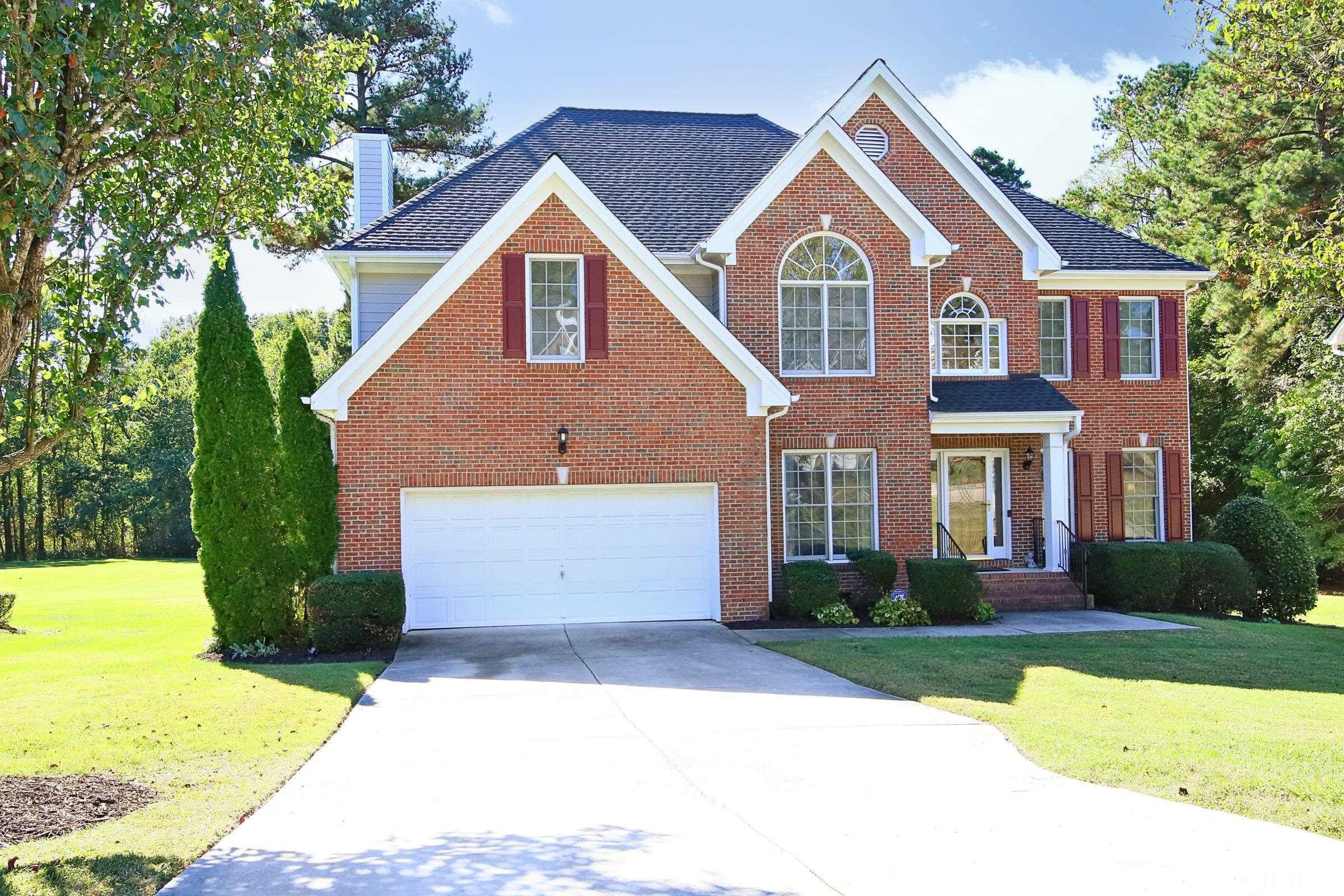 3307 Meadowrun Drive Durham, NC 27707 - Photo 1 of 29 a front view of a house with a yard and trees
