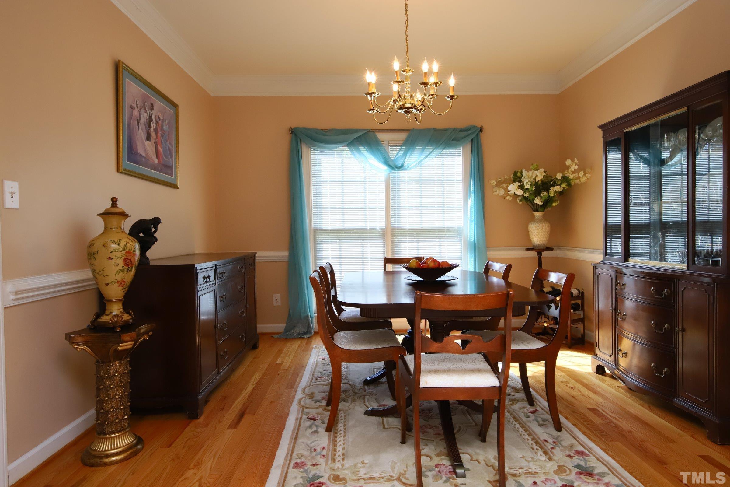3307 Meadowrun Drive Durham, NC 27707 - Photo 14 of 29 a view of a dining room with furniture and chandelier