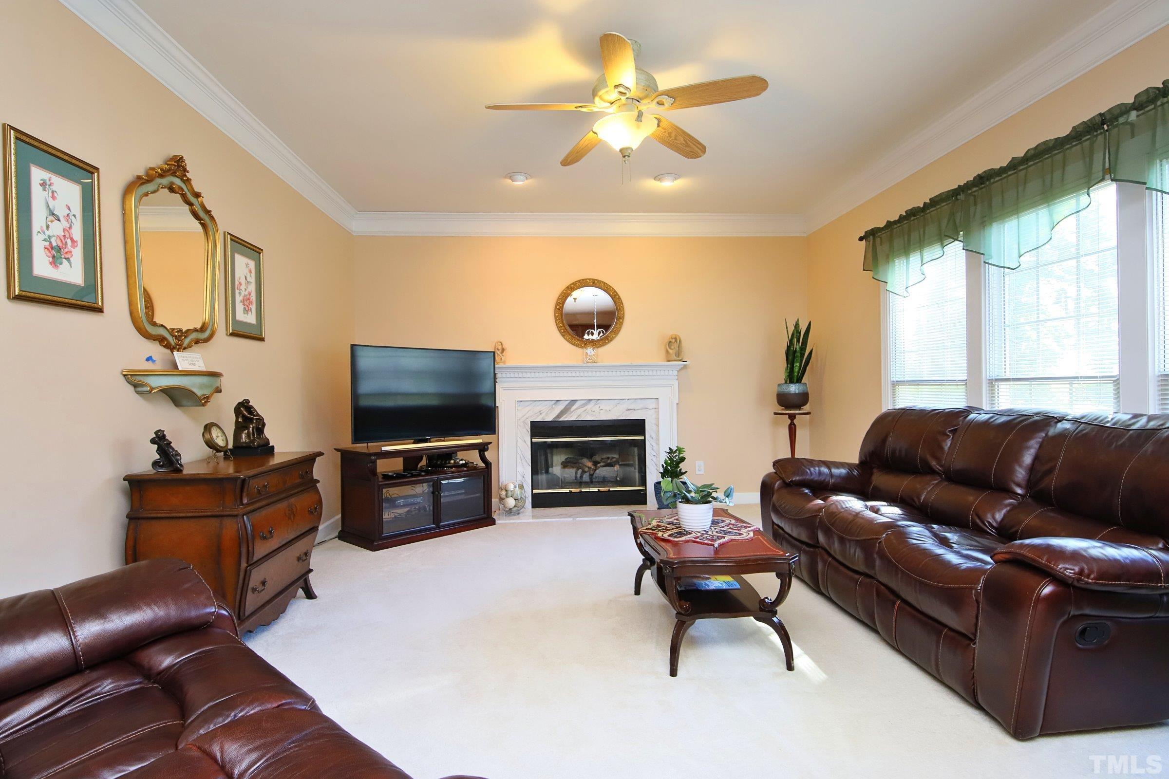 3307 Meadowrun Drive Durham, NC 27707 - Photo 15 of 29 a living room with furniture a fireplace and a flat screen tv