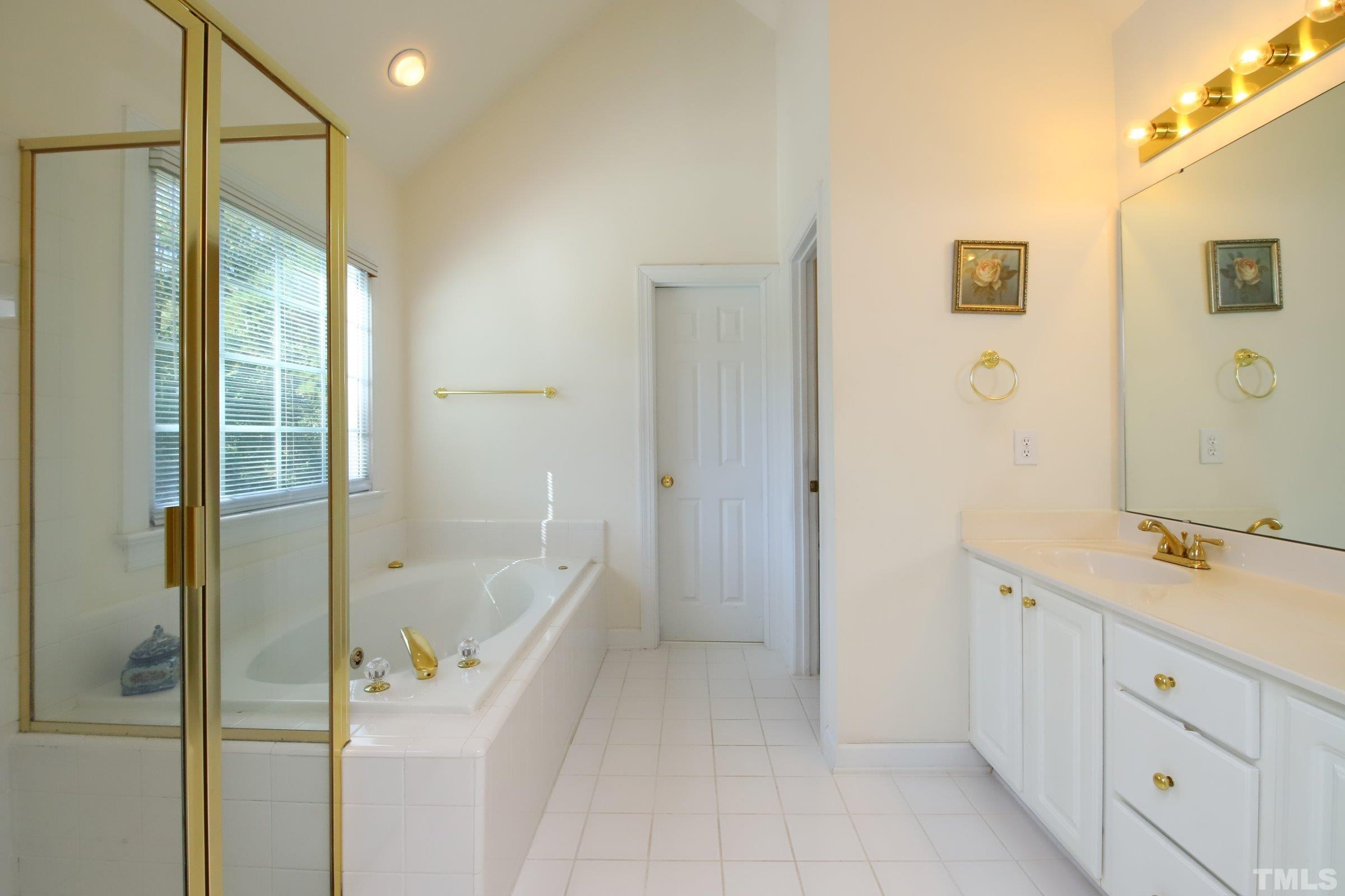 3307 Meadowrun Drive Durham, NC 27707 - Photo 24 of 29 a bathroom with a tub sink and mirror