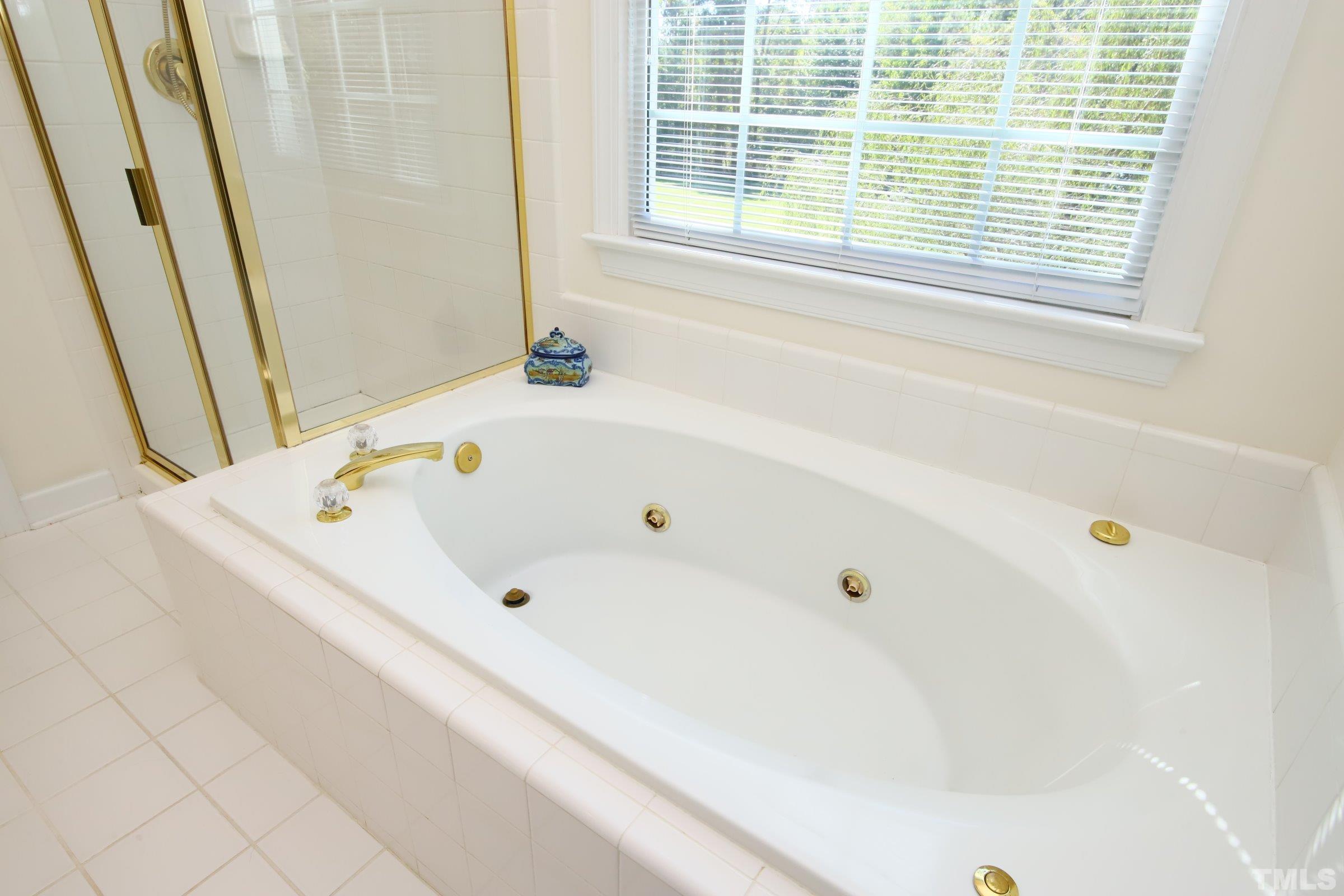 3307 Meadowrun Drive Durham, NC 27707 - Photo 25 of 29 a white bath tub sitting next to a window