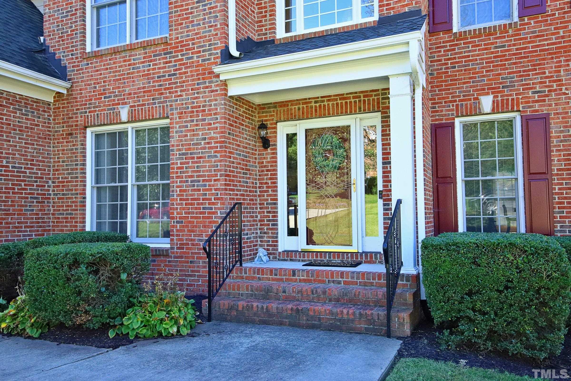 3307 Meadowrun Drive Durham, NC 27707 - Photo 3 of 29 a view of a house with large windows and plants