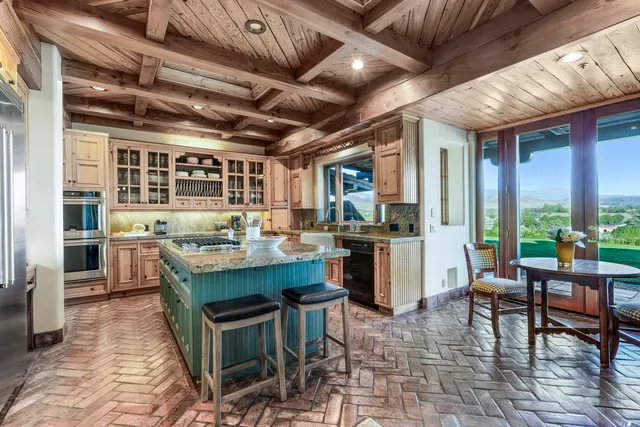 a kitchen with stainless steel appliances granite countertop a stove a sink and a refrigerator