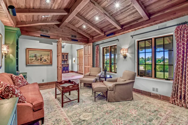 a living room with furniture a rug and a window