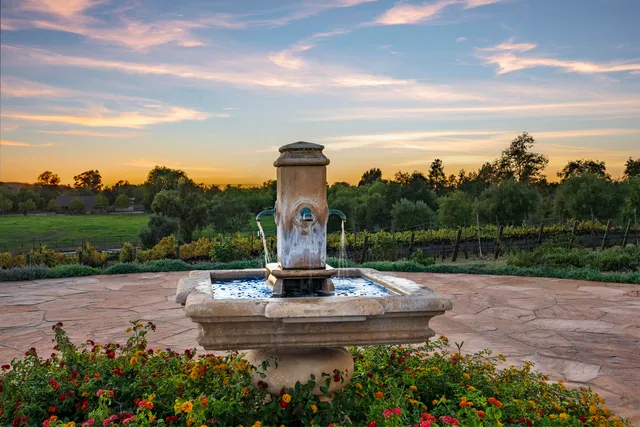 a view of a swimming pool with a table and chairs under an umbrella