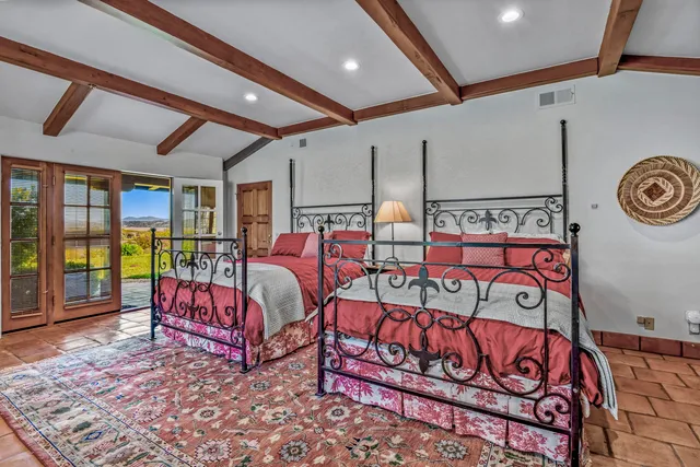 a bathroom with a granite countertop sink a toilet a mirror and shower