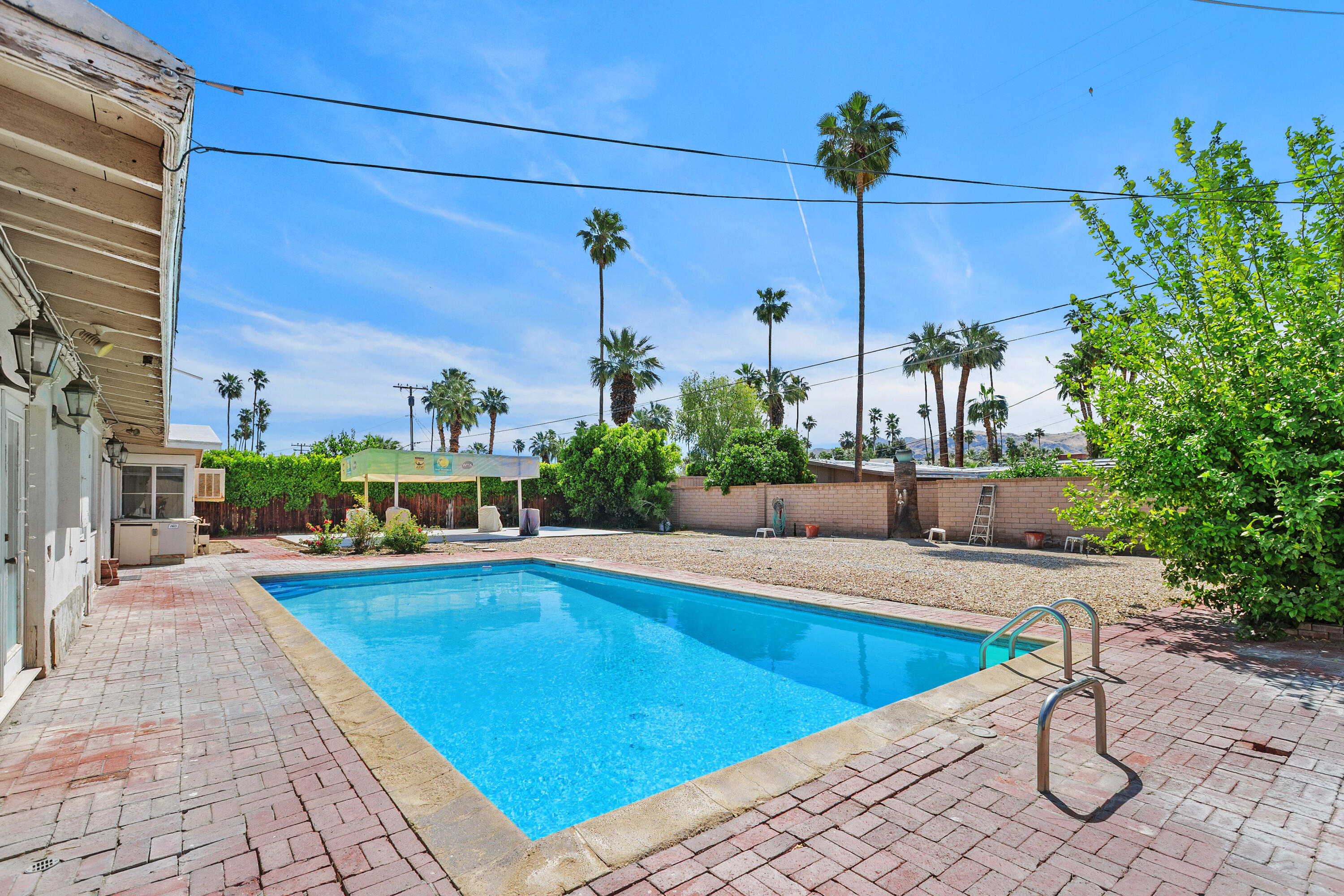 1077 South Riverside Drive Palm Springs, CA 92264 - Photo 32 of 35 a view of a swimming pool with a lounge chairs