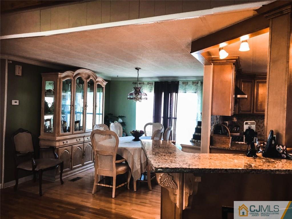 6 Poe Road, Unit 6 North Brunswick, NJ 08902 - Photo 3 of 22 a dining room with furniture and wooden floor