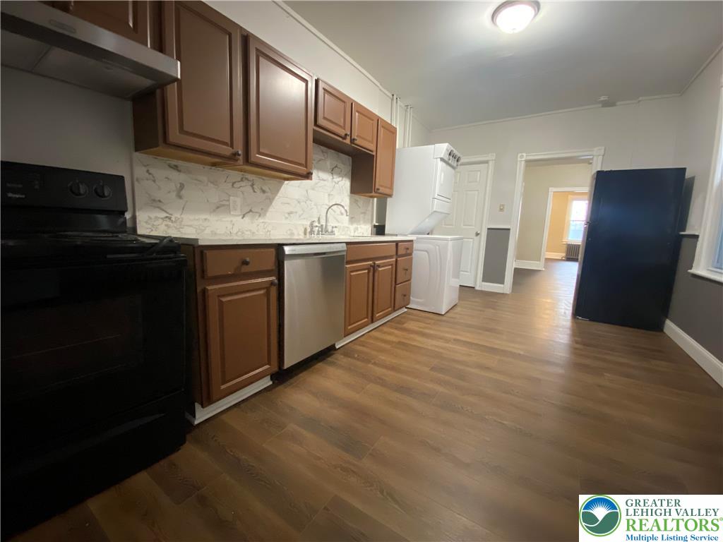 122 South Spruce Street Nazareth, PA 18064 - Photo 2 of 11 a kitchen with granite countertop stainless steel appliances and wooden cabinets