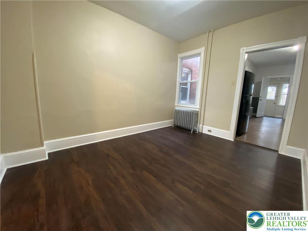 122 South Spruce Street Nazareth, PA 18064 - Photo 6 of 11 an empty room with wooden floor and mirror