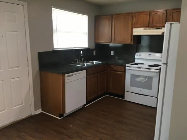 a kitchen with a sink and a stove top oven