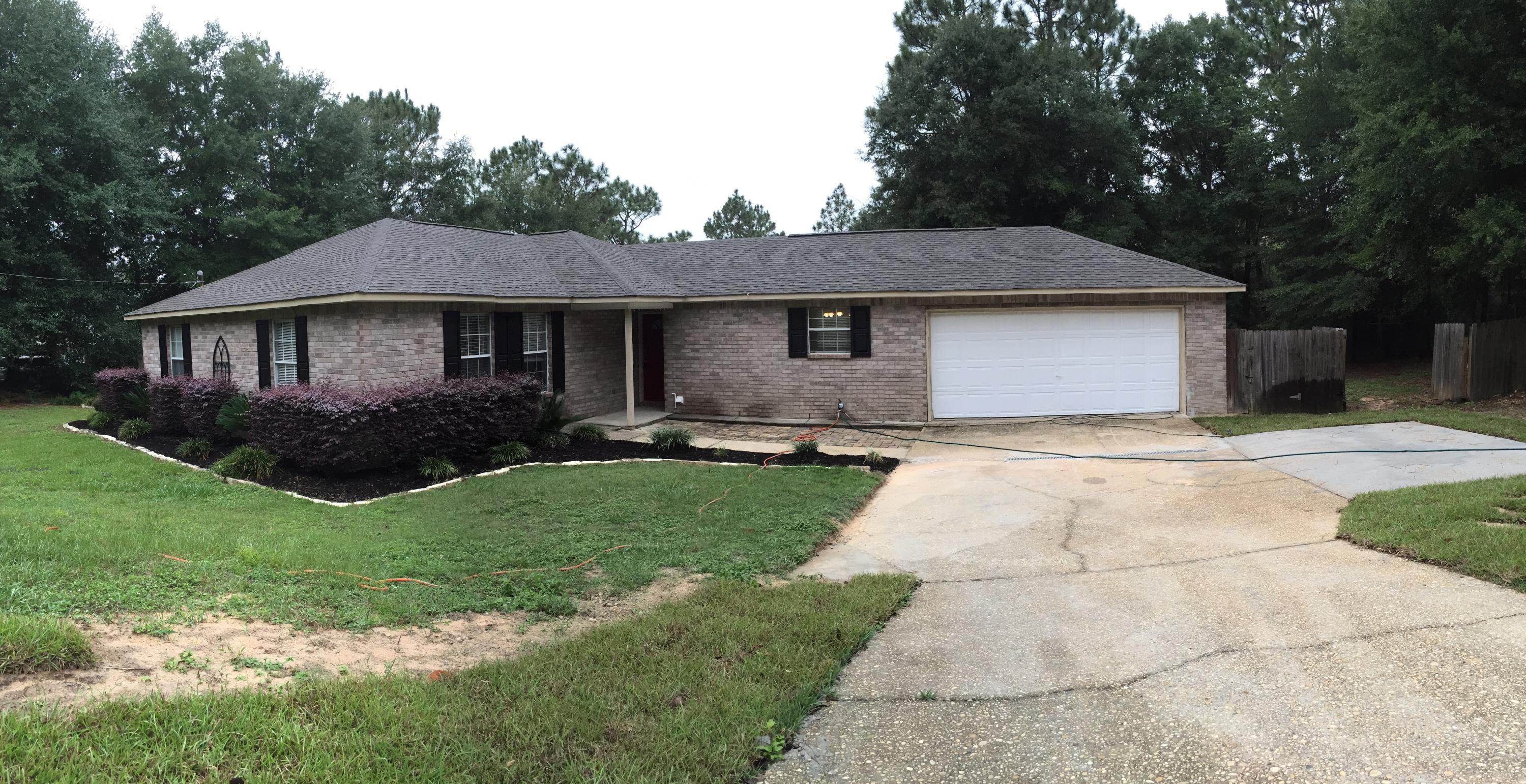 5780 Wildwood Road Crestview, FL 32536 - Photo 29 of 33 a front view of a house with garden