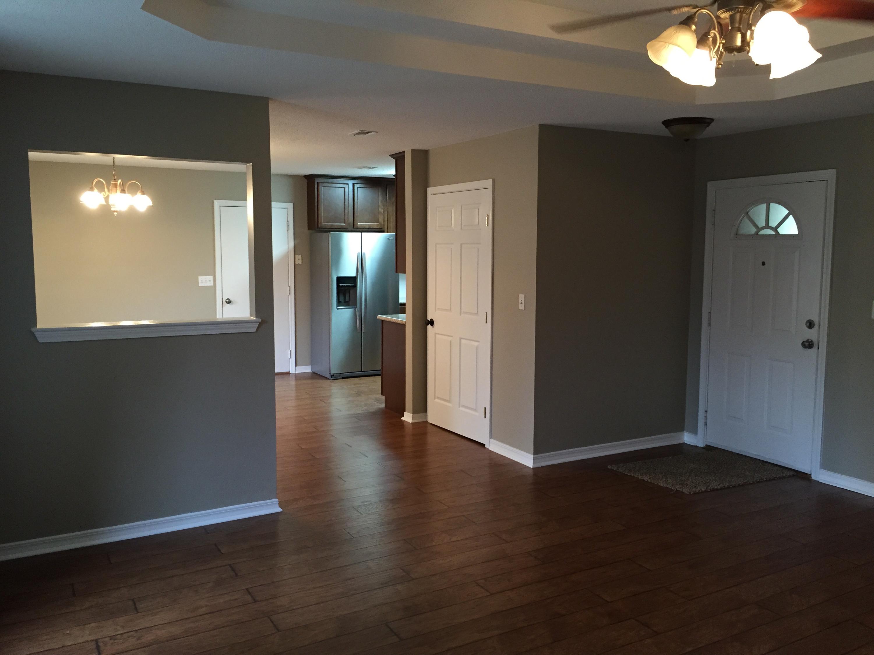 5780 Wildwood Road Crestview, FL 32536 - Photo 3 of 33 an empty room with wooden floor and mirror