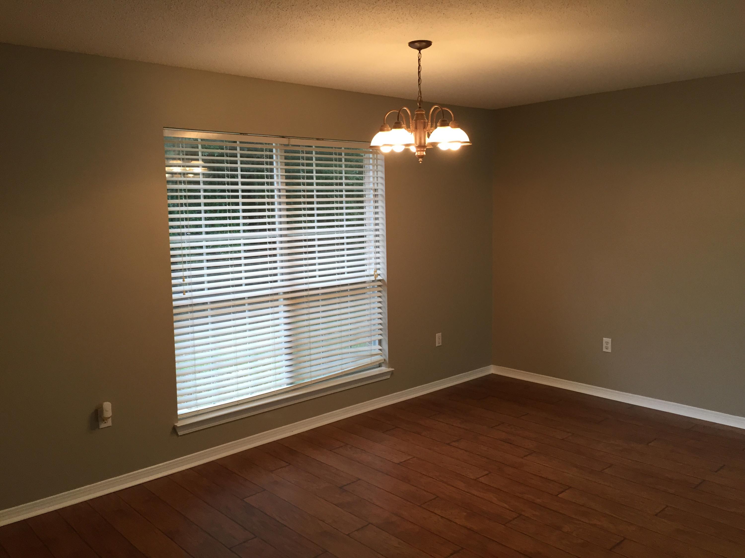 5780 Wildwood Road Crestview, FL 32536 - Photo 4 of 33 a view of a livingroom with a chandelier a fireplace and wooden floor