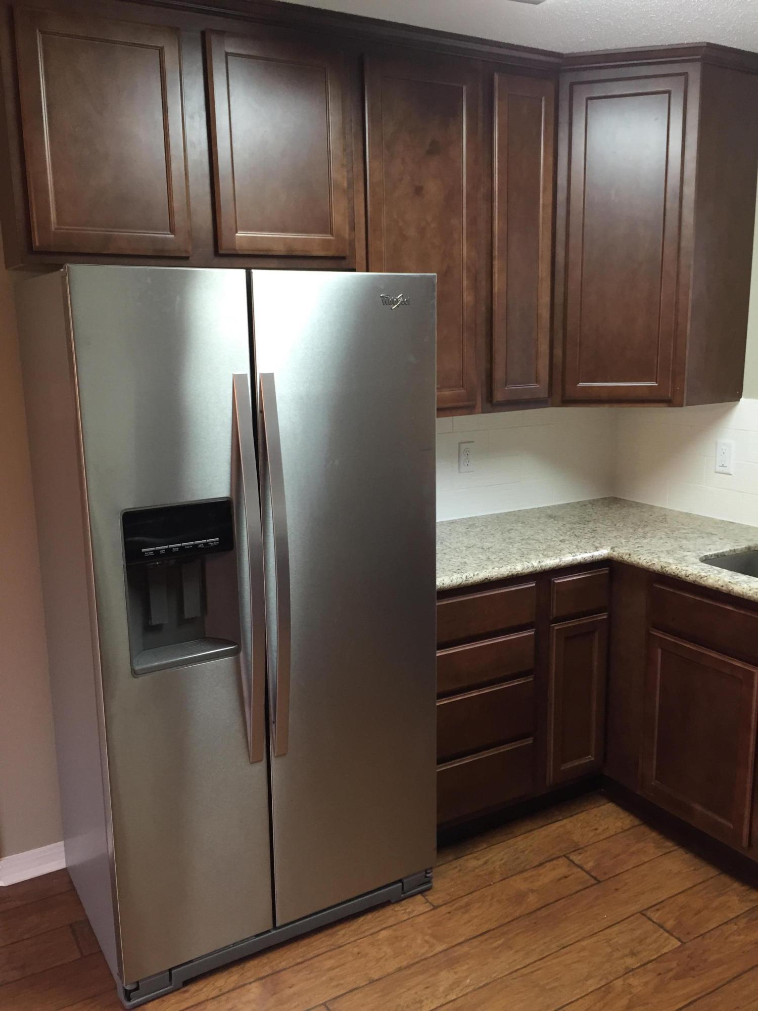5780 Wildwood Road Crestview, FL 32536 - Photo 8 of 33 a kitchen with stainless steel appliances granite countertop cabinets and wooden floor