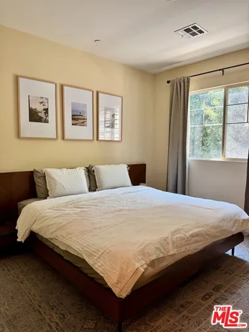 a bedroom with bed and a window