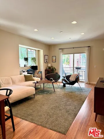 a living room with furniture rug and window